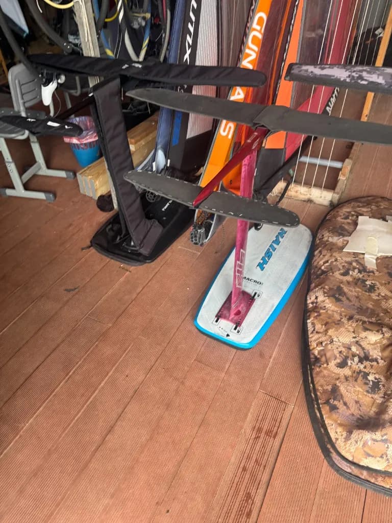 Hydrofoil board with mast, front wing and stabilizer on a wooden deck